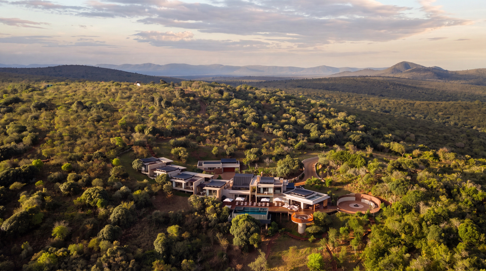 A Thanda Royal Residence and its pool deck in the green of the reserve
