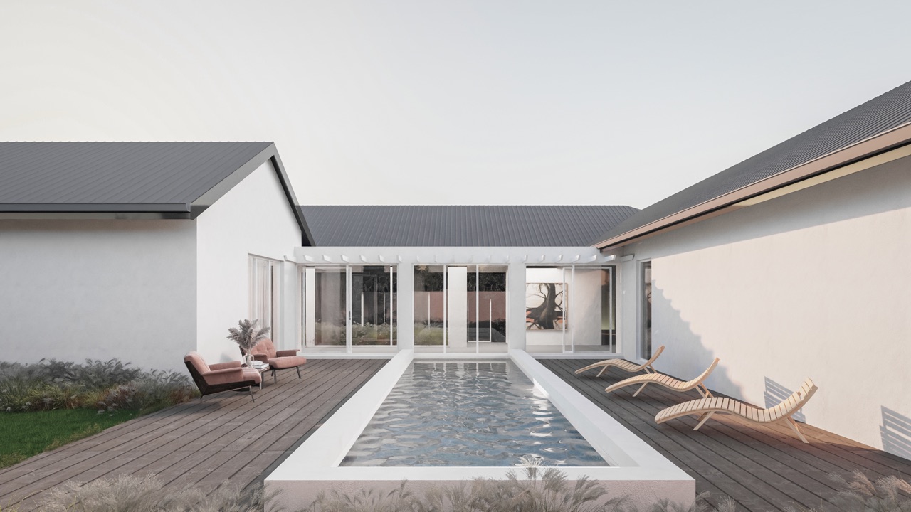 The lap pool courtyard at Villa VDV, sheltered by the residence's white gabled wings