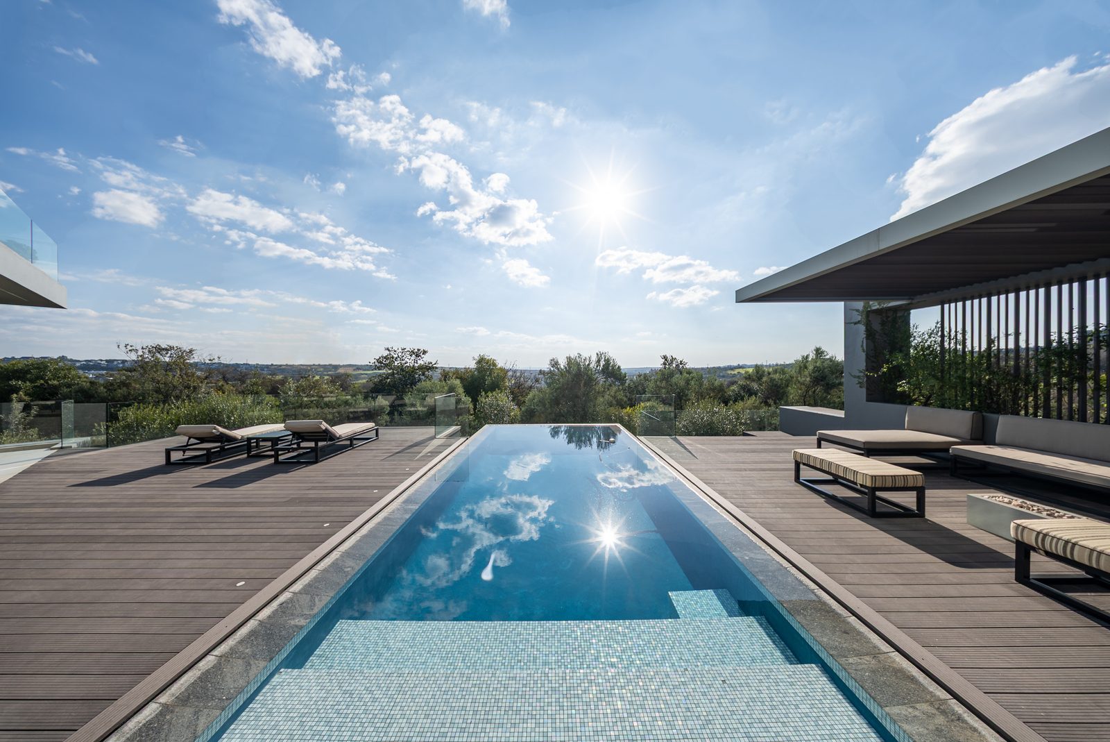 The heated rim flow pool facing the sunset over the parkland