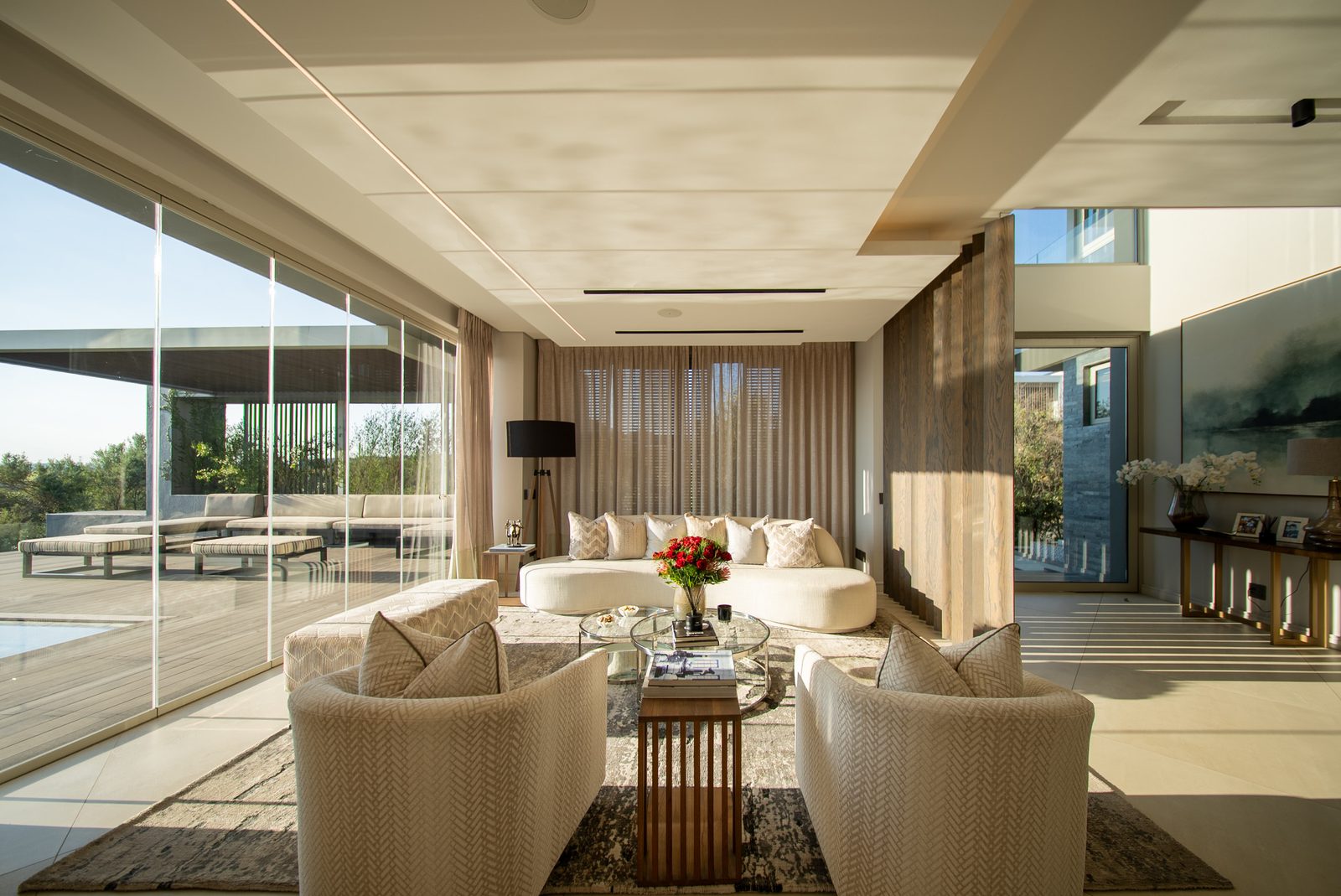 Lounge seating behind walls of stacking glass
