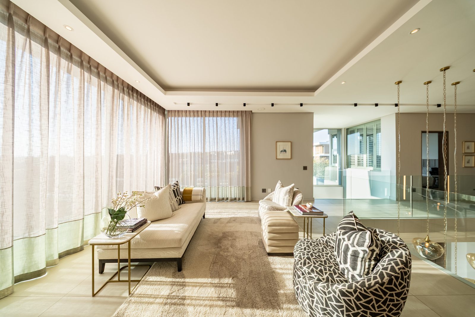 Sitting room in morning light behind sheer curtains