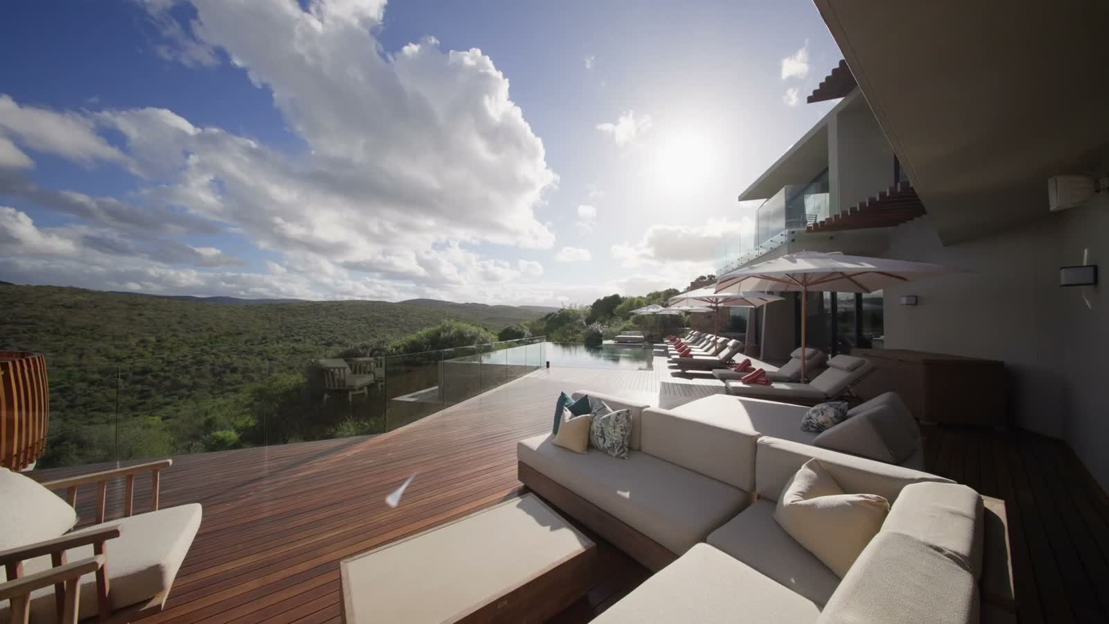 Pool deck of Villa Thandawena in afternoon light above the reserve