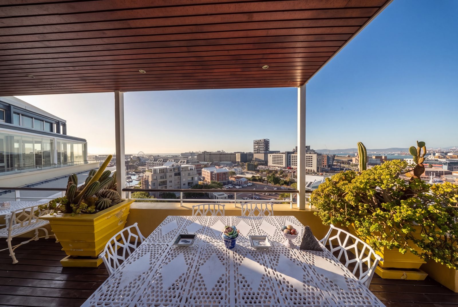 The balcony dining corner, the harbour at its edge