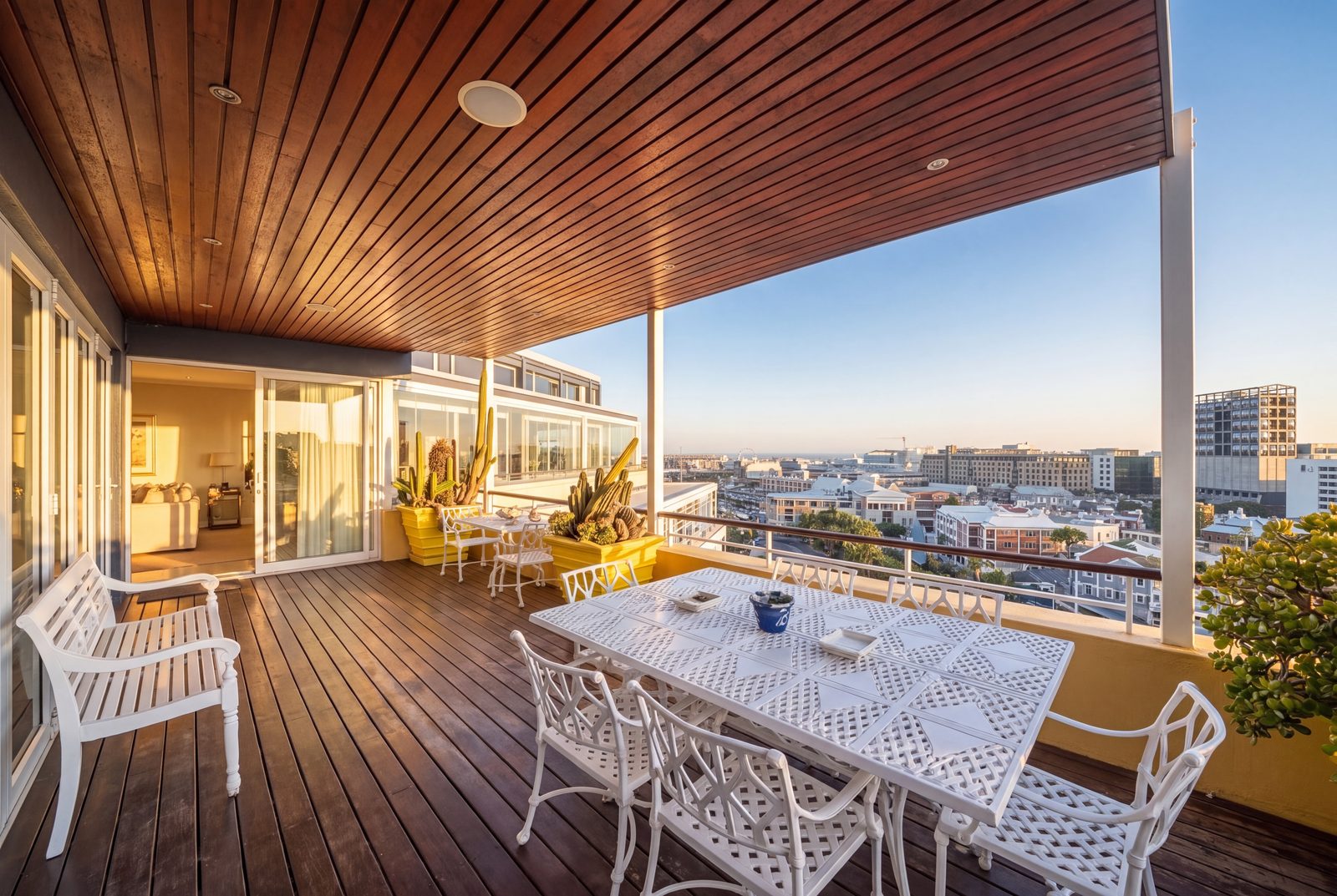 The grand covered terrace, timber ceiling and cactus planters over the city