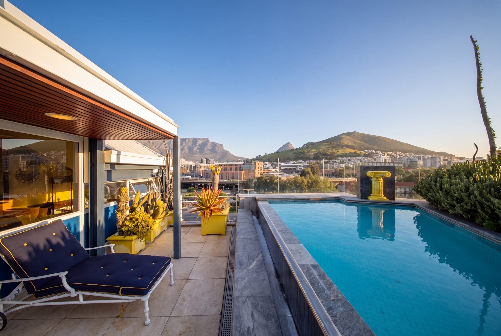 The rooftop rim flow pool, Table Mountain, Lion's Head and Signal Hill beyond
